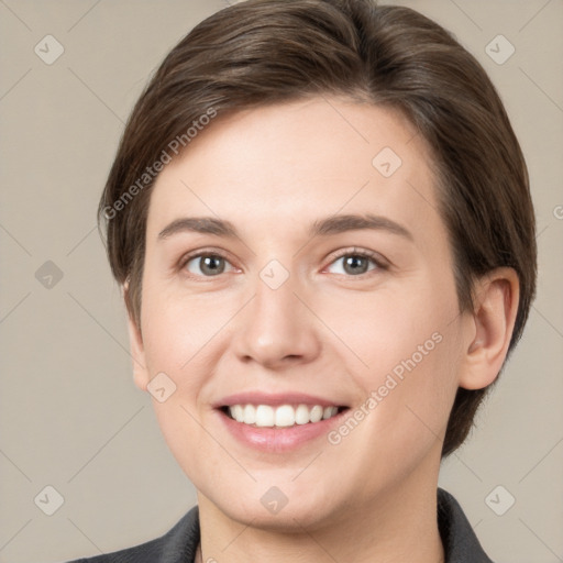 Joyful white young-adult female with short  brown hair and grey eyes