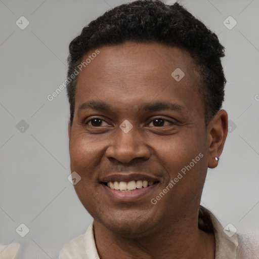 Joyful black young-adult male with short  brown hair and brown eyes