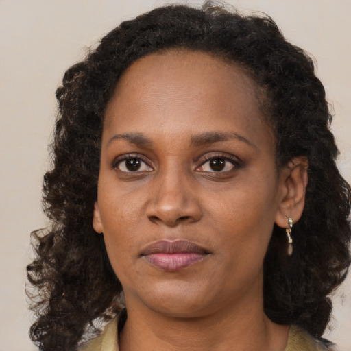 Neutral black young-adult female with long  brown hair and brown eyes