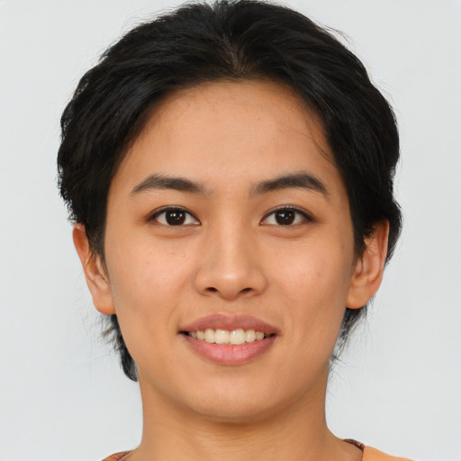Joyful asian young-adult female with short  brown hair and brown eyes