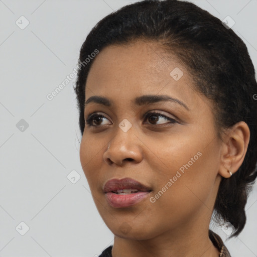 Joyful black young-adult female with medium  black hair and brown eyes