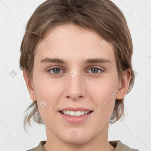 Joyful white young-adult female with medium  brown hair and grey eyes