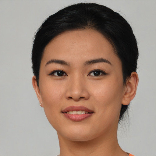 Joyful asian young-adult female with short  black hair and brown eyes