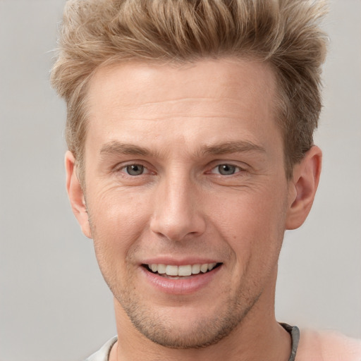 Joyful white adult male with short  brown hair and grey eyes