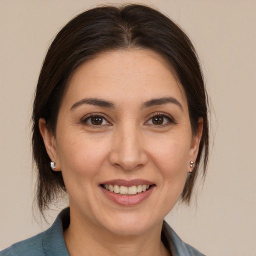 Joyful white adult female with medium  brown hair and brown eyes