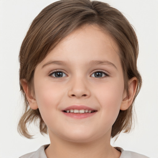 Joyful white child female with medium  brown hair and grey eyes