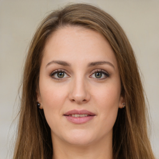 Joyful white young-adult female with long  brown hair and green eyes