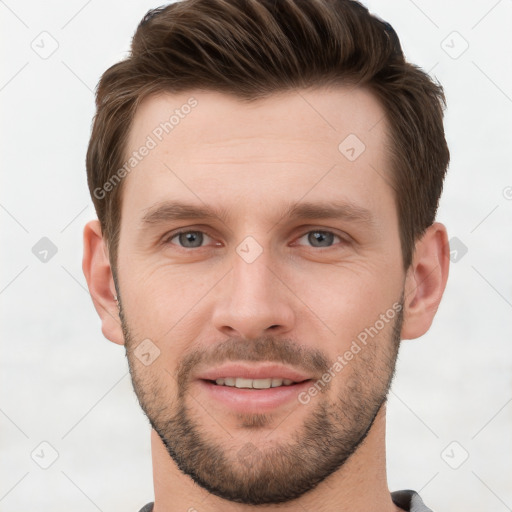 Joyful white young-adult male with short  brown hair and grey eyes