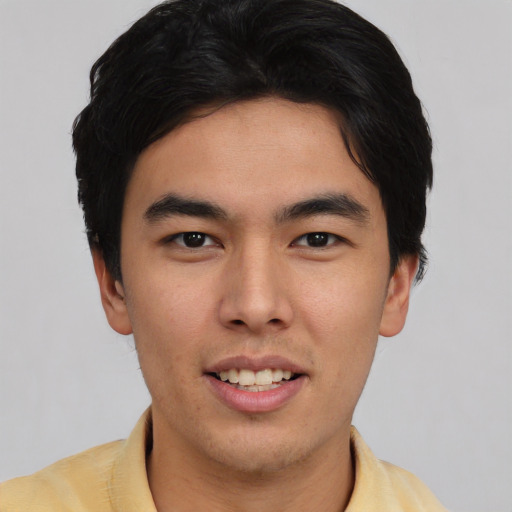 Joyful asian young-adult male with short  black hair and brown eyes