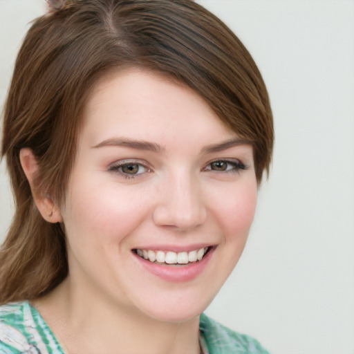 Joyful white young-adult female with medium  brown hair and green eyes