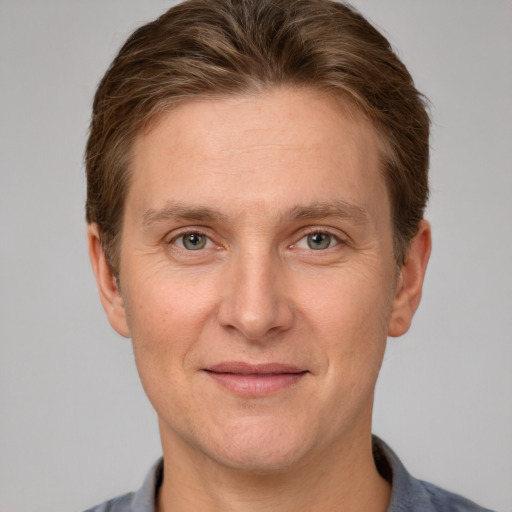 Joyful white adult male with short  brown hair and grey eyes