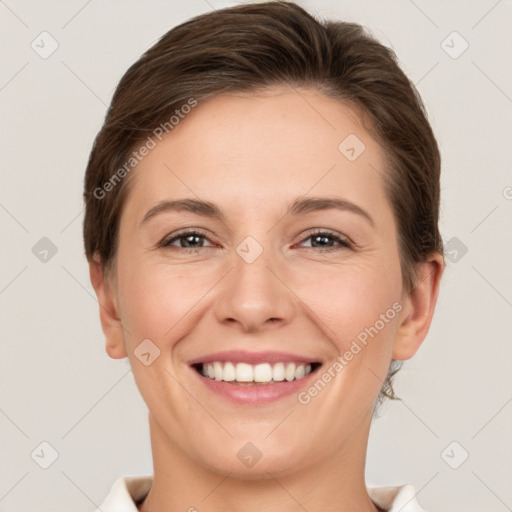 Joyful white young-adult female with short  brown hair and brown eyes