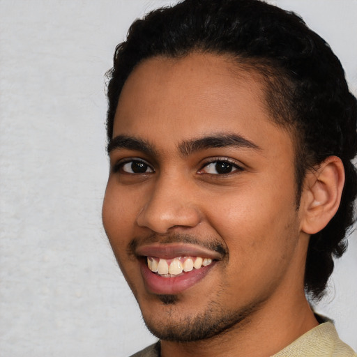 Joyful latino young-adult male with short  black hair and brown eyes