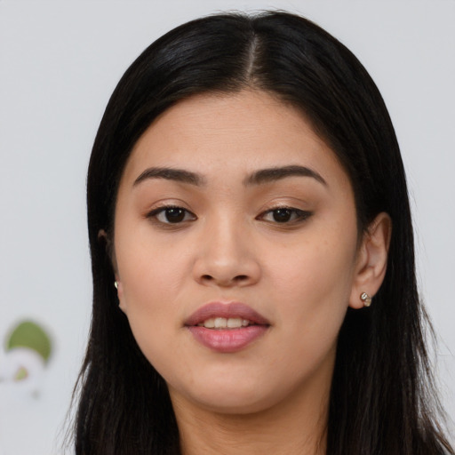 Joyful asian young-adult female with long  brown hair and brown eyes