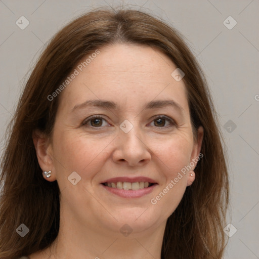 Joyful white adult female with long  brown hair and grey eyes