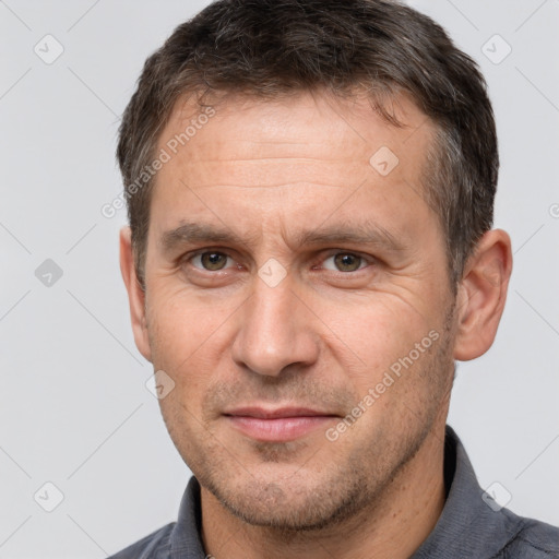 Joyful white adult male with short  brown hair and brown eyes