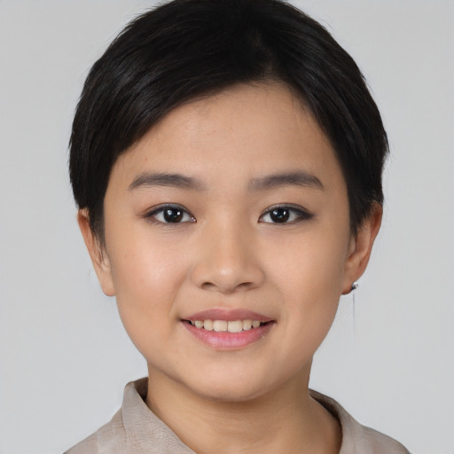 Joyful asian young-adult female with short  black hair and brown eyes