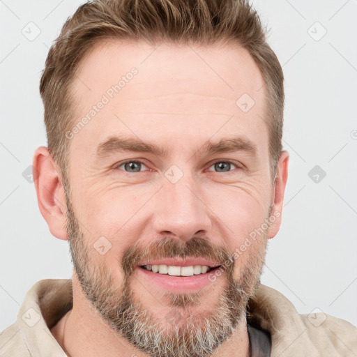 Joyful white adult male with short  brown hair and grey eyes