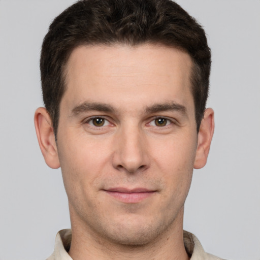 Joyful white young-adult male with short  brown hair and brown eyes