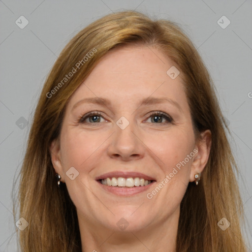 Joyful white adult female with long  brown hair and grey eyes