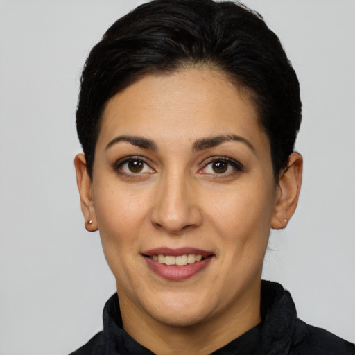 Joyful white adult female with short  black hair and brown eyes