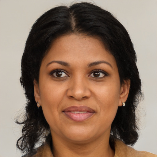 Joyful black adult female with medium  brown hair and brown eyes