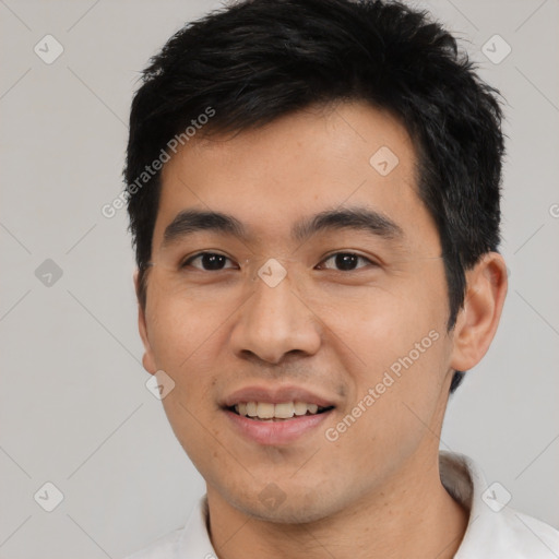 Joyful asian young-adult male with short  black hair and brown eyes