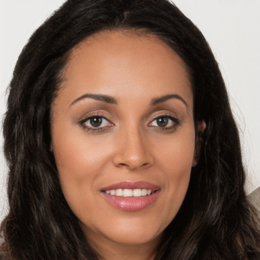 Joyful white young-adult female with long  brown hair and brown eyes