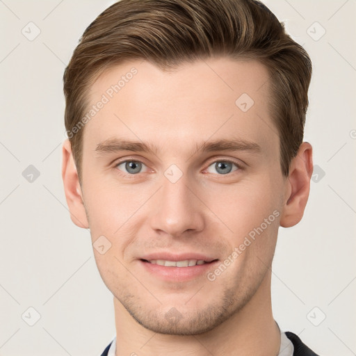 Joyful white young-adult male with short  brown hair and grey eyes