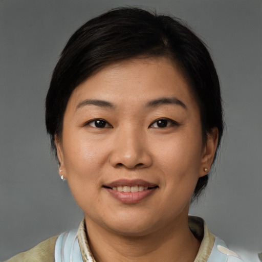 Joyful asian young-adult female with short  brown hair and brown eyes