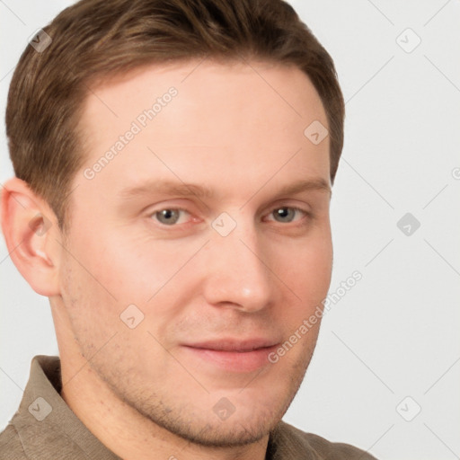 Joyful white young-adult male with short  brown hair and grey eyes