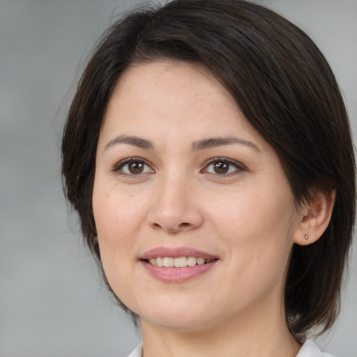 Joyful white young-adult female with medium  brown hair and brown eyes