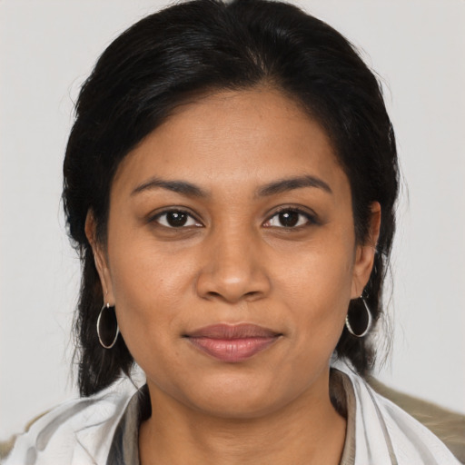 Joyful latino young-adult female with medium  black hair and brown eyes