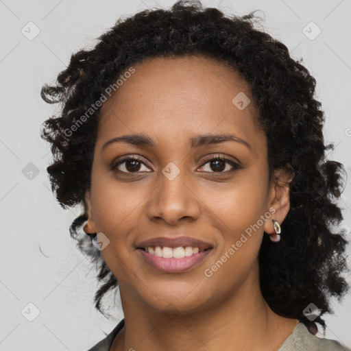 Joyful black young-adult female with long  black hair and brown eyes