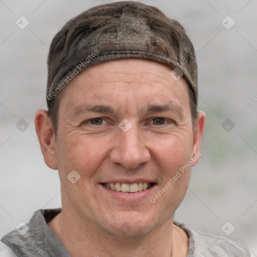 Joyful white adult male with short  brown hair and grey eyes