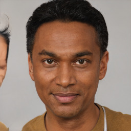 Joyful black adult male with short  black hair and brown eyes