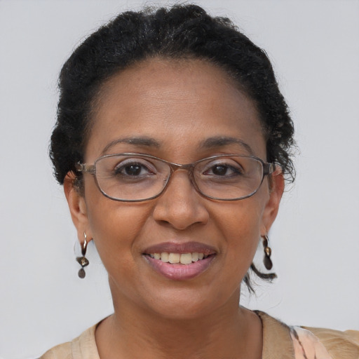 Joyful black adult female with short  brown hair and brown eyes