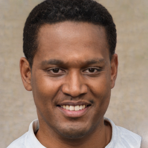 Joyful latino young-adult male with short  brown hair and brown eyes