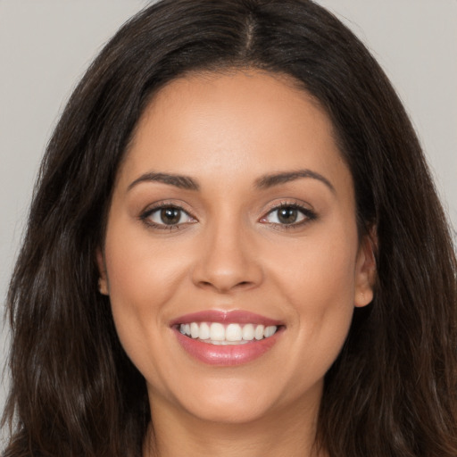 Joyful white young-adult female with long  brown hair and brown eyes