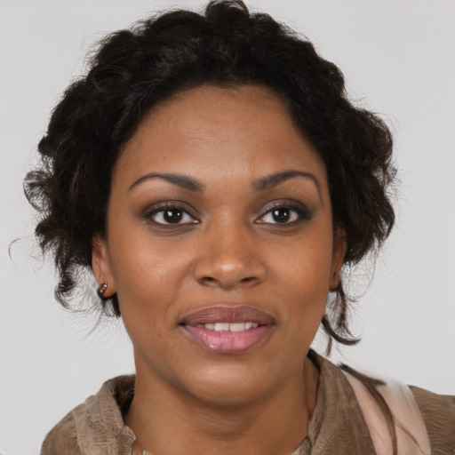 Joyful black young-adult female with medium  brown hair and brown eyes