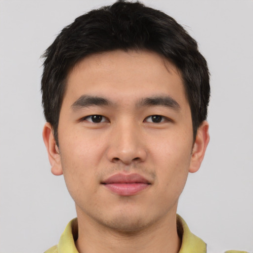 Joyful asian young-adult male with short  brown hair and brown eyes
