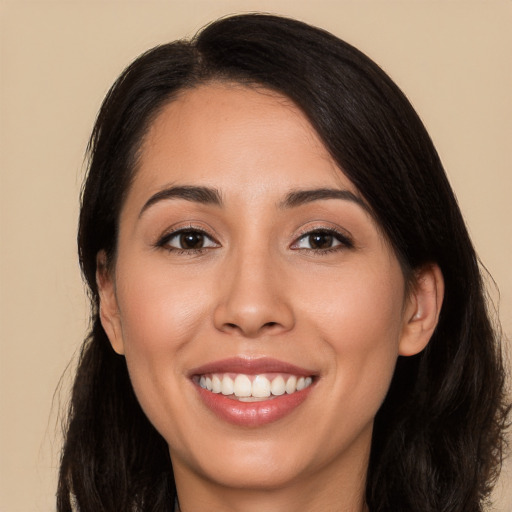 Joyful white young-adult female with long  black hair and brown eyes