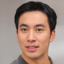 Joyful asian young-adult male with short  black hair and brown eyes