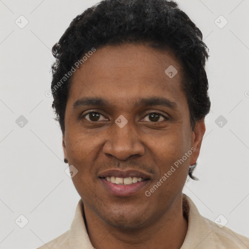 Joyful black young-adult male with short  black hair and brown eyes