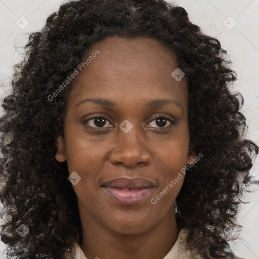 Joyful black young-adult female with long  brown hair and brown eyes