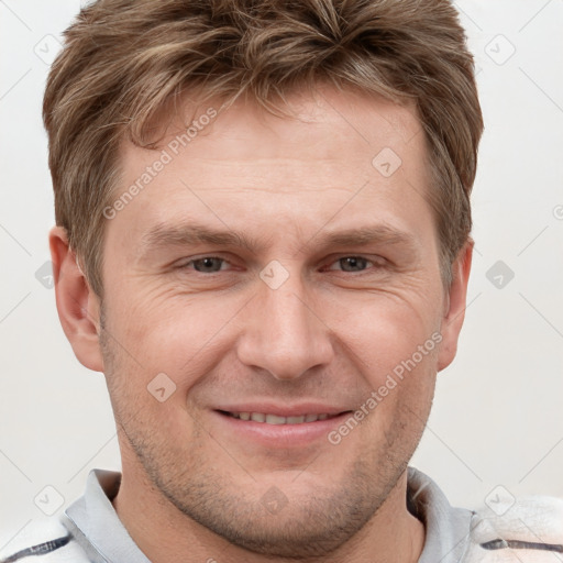 Joyful white adult male with short  brown hair and grey eyes