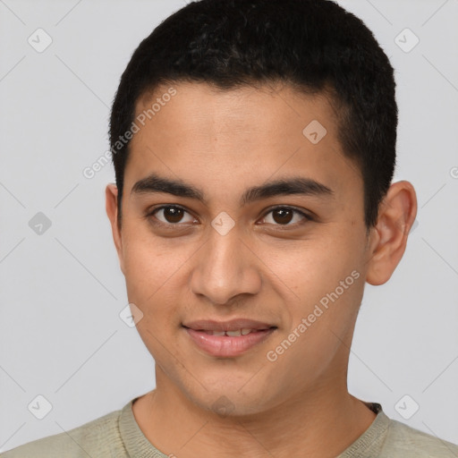 Joyful latino young-adult male with short  brown hair and brown eyes