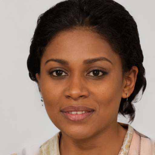 Joyful black young-adult female with medium  brown hair and brown eyes
