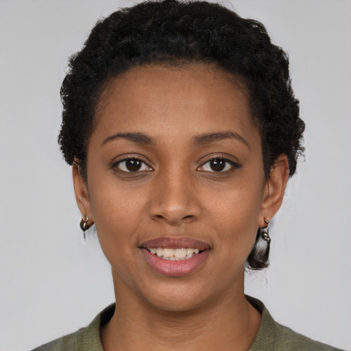 Joyful black young-adult female with short  black hair and brown eyes