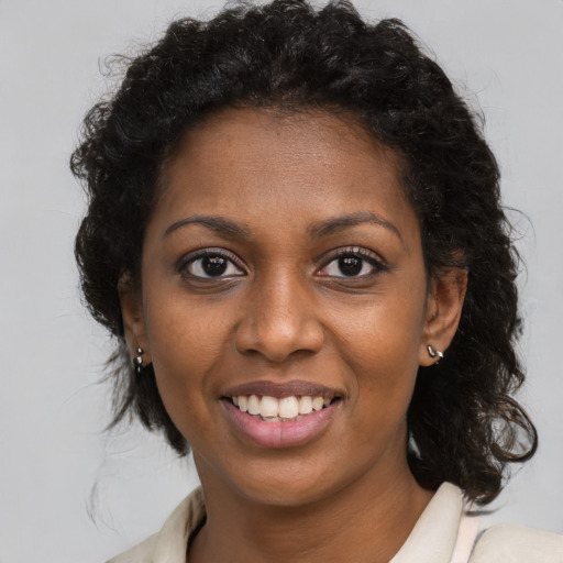Joyful black young-adult female with medium  brown hair and brown eyes